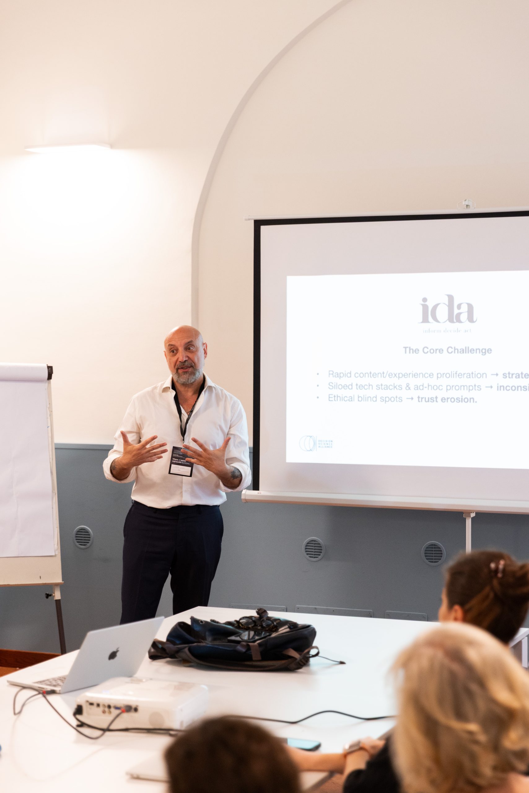 Conference speaker presenting a slide on a projector